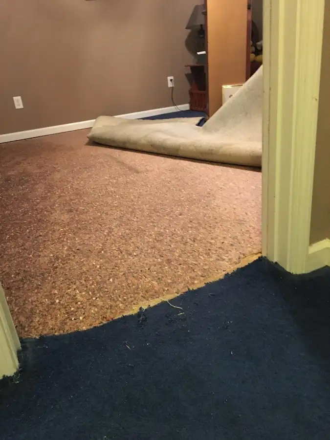 Carpet pad removal revealing water damage during Water Mitigation Services in Bridge City