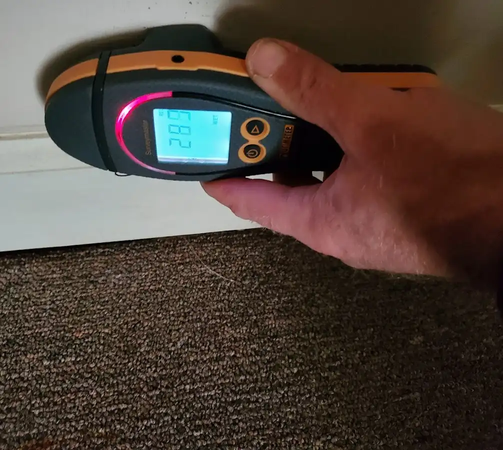 Moisture detection at baseboard during Burst Pipe Cleanup in Bridge City
